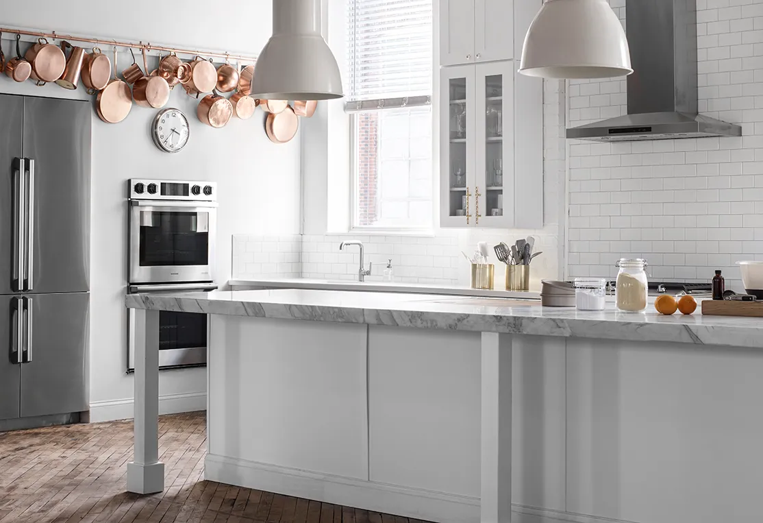 3/4 shot of Kitchen studio with double oven and refrigerator